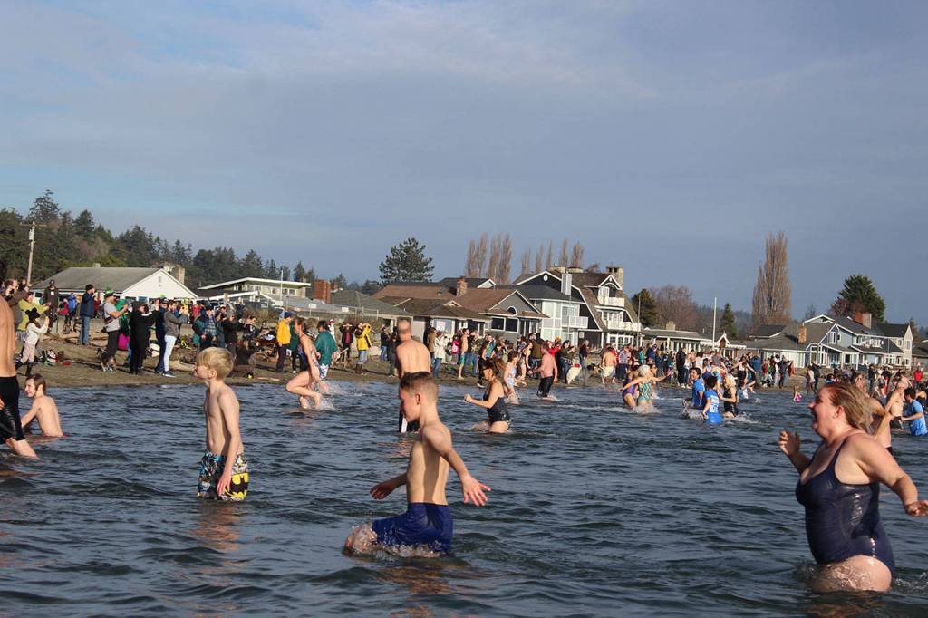 Brave, bone-chilled bathers race back to shore.