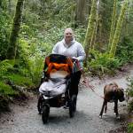Elizabeth Nienhuis takes her daughter, Phoebe, and family dog, Rex, on a stroll down the Waterman Trail. Nienhuis says she regularly hikes the South Whidbey trail system in the mornings after dropping her older kids off at school. (Photo by Patricia Guthrie/Whidbey News Group)