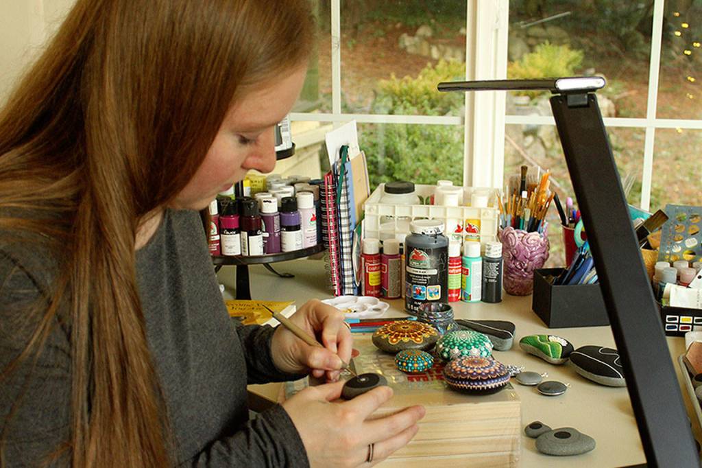 The studio space for Renee Boyce keeps shrinking as her house is slowly renovated. She works in a narrow porch space surrounded by wraparound windows facing Holmes Harbor.