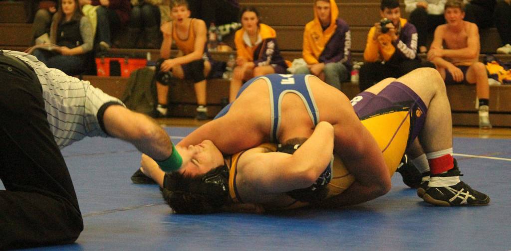 The official is about to slap the mat, signifying a fall for South Whidbeys Kobe Balora, top.(Photo by Jim Waller/South Whidbey Record)