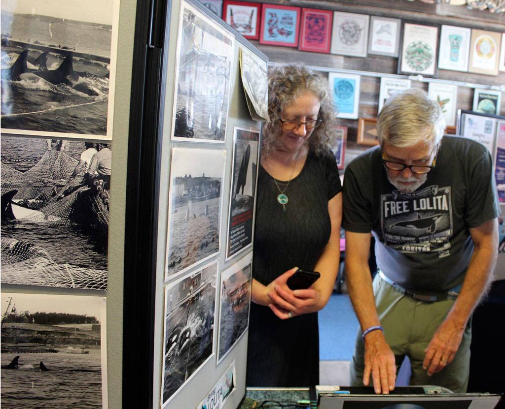 Orca Networks Susan Berta and Howard Garrett have led the fight to return Lolita to her home waters of Puget Sound. In August 2018, they set up an educational display about the killer whale round-ups on Coupeville wharf before leading a commemorative ceremony honoring captured and deceased orcas. (Photo by Patricia Guthrie/Whidbey News Group)