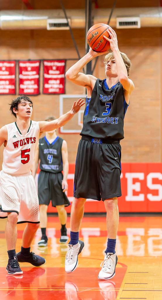 Kody Newman (3) shoots a jumper ahead of the defense of Coupevilles Hawthorne Wolfe. Newman scored a game-high 33 points for the Falcons.(Photo by John Fisken)