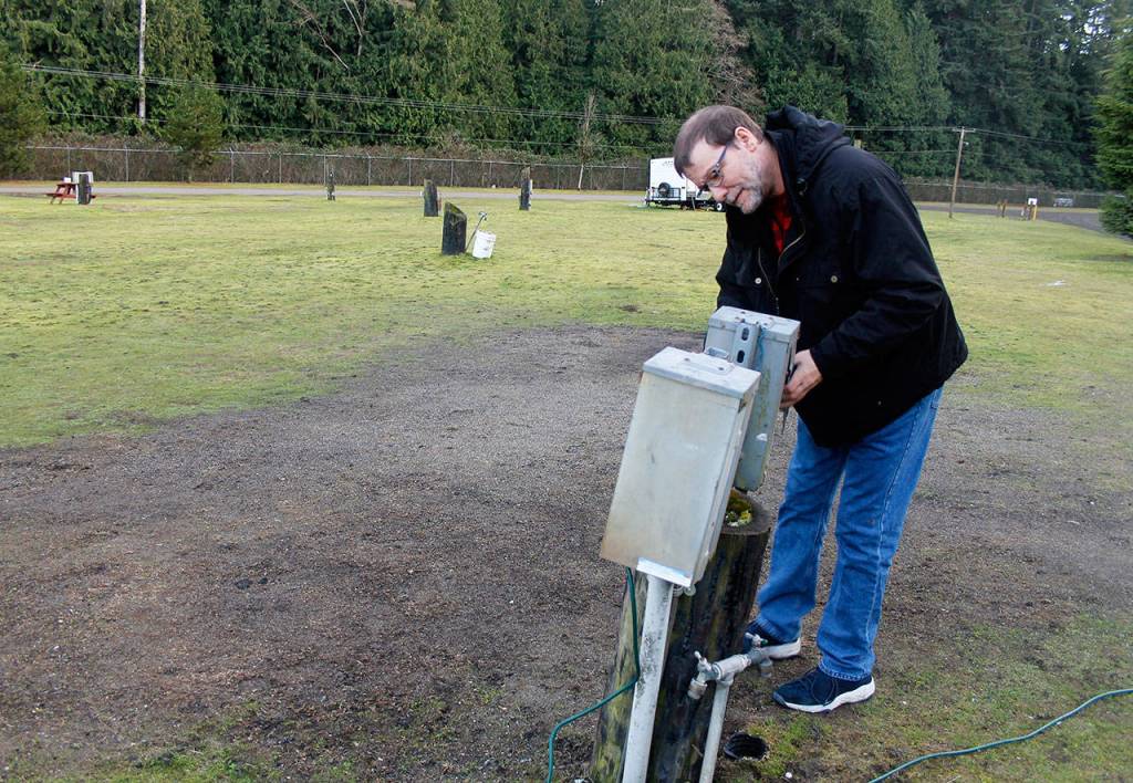 Ben Wooldridge examines the electrical connections that were damaged during the Nov. 8 motor home fire at Island County Fairgrounds. (Photo by Patricia Guthrie/Whidbey New Group)