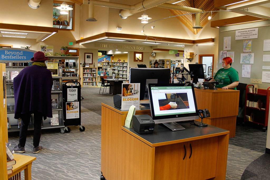 Freeland Library may look bigger after its recent makeover but its the same dimensions. New carpeting and furniture, brighter paint and a rearrangement of its shelves and section created a more open and flowing space. (Photo by Patricia Guthrie/Whidbey News Group)