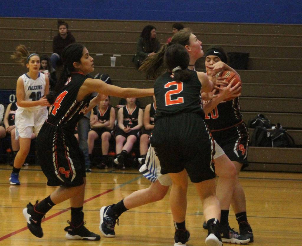 Ella Wood, center, draws a crowd of Granite Falls defenders on the way to the hoop.(Photo by Jim Waller/South Whidbey Record)
