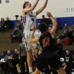 Nick Young goes to the hoop over Coupevilles Sean Toomey-Stout.(Photo by Jim Waller/ South Whidbey Record)