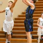 Levi Buck puts up a jumper past Merdians Cameron Webster. (Photo by John Fisken)