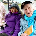 Roberta Brown and Peter Lawlor get a ride on a golf cart during a parade in Langley. (Photo by Patricia Guthrie/Whidbey News Group)