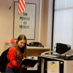 South Whidbey High School freshman Elizabeth Findley makes sure a Chromebook is charged before checking it out of the library. (Photos by Patricia Guthrie/Whidbey News Group)