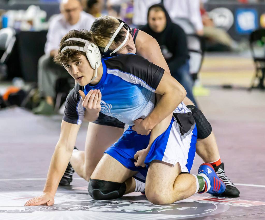 Clay OBrien works to get free from Newports Jed Cupp.(Photo by John Fisken)