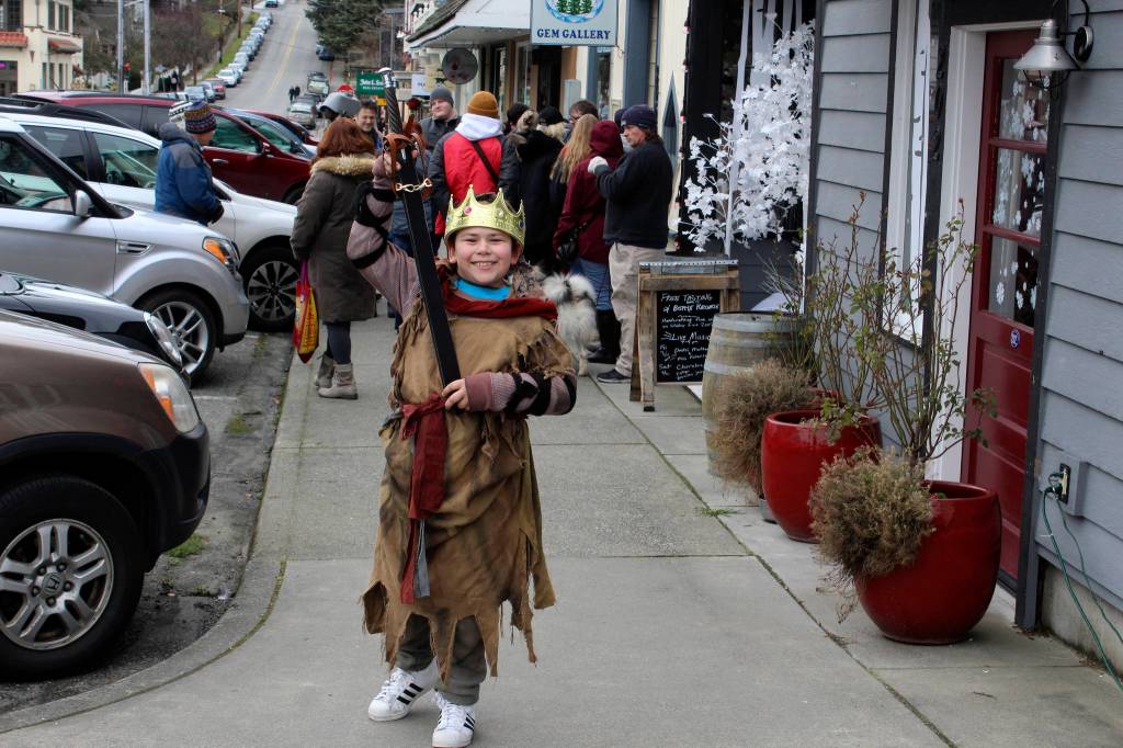 Shayne Thomas, playing a young King Arthur, fought his way through Langleys many overflowing sidewalks as he searched for his wizard mentor, Merlin. (Photo by Patricia Guthrie/Whidbey News Group)