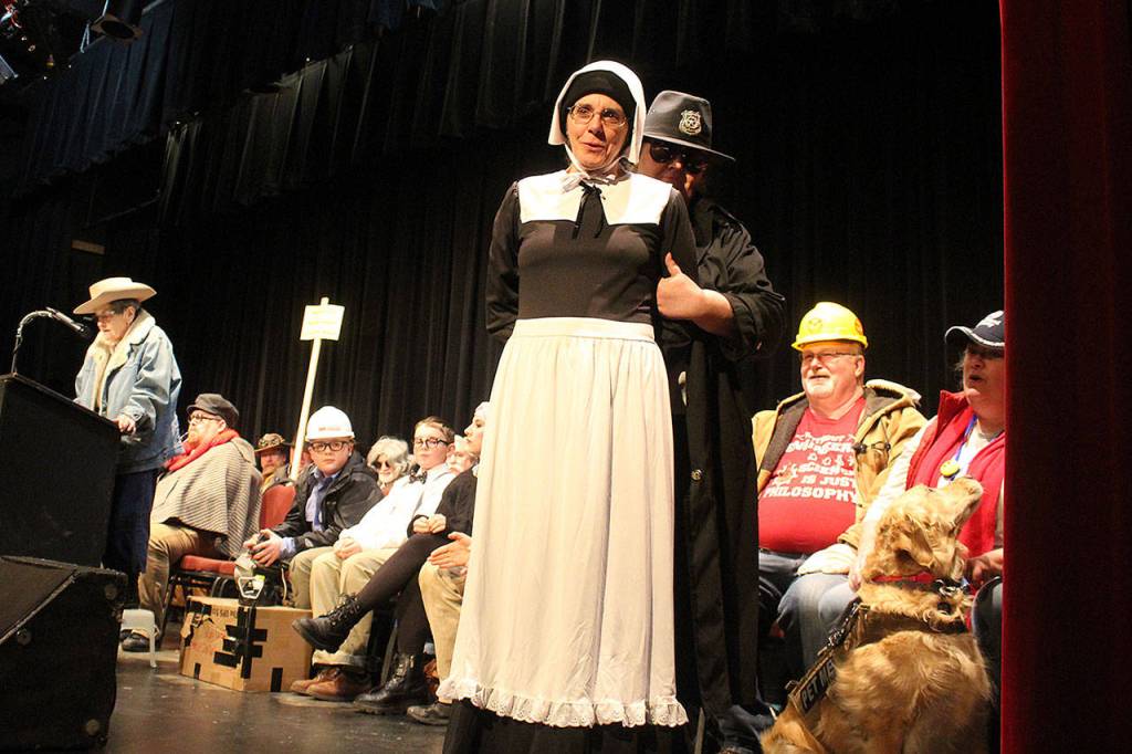 Linda Trefts, playing Elizabeth Howe, is arrested and led off the stage Sunday by Officer Polly Graph for the murder of Prof. E.D. Brown. Officer Graph is really Loretta Martin, author of many Mystery Weekend plots, including this years crime, Killing Time. (Photo by Patricia Guthrie/Whidbey News Group)