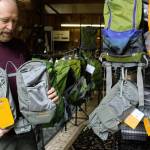 Rich Murphy shows tandem packs that can attach to backpacks and be worn in front to help with balance. (Photos by Patricia Guthrie/Whidbey News Group)