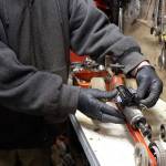 Turning another pipe wrench into a drag car and recycled art work, John Norris tries on some possible parts. (Photo by Patricia Guthrie/Whidbey News Group)