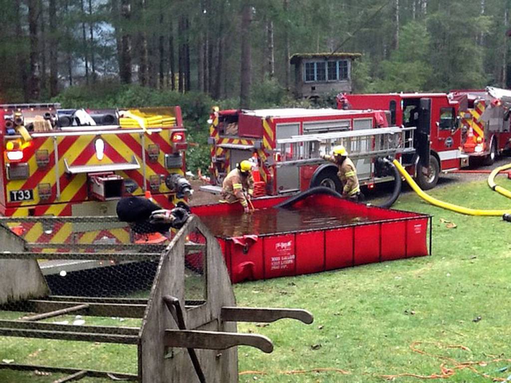 Firefighters used a tanker truck and a small portable holding pool on the fire that broke out on Nancye Road in Langley. (Photo provided)