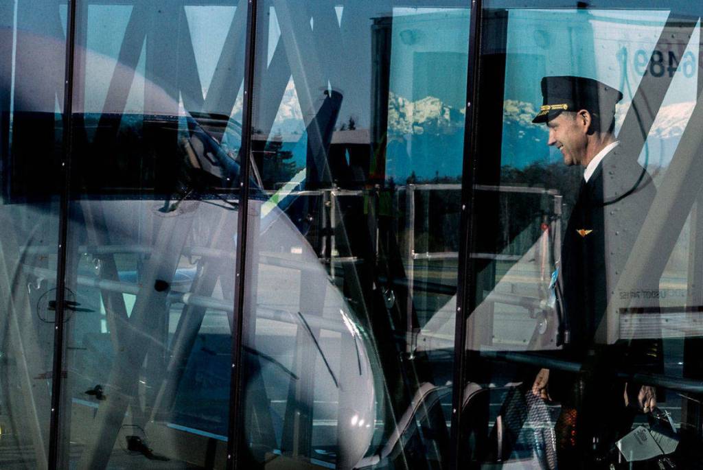 A pilot begins boarding the first plane scheduled for the day during Mondays grand opening of the the Paine Field Airport terminal. (Photo by Olivia Vanni/The Everett Daily Herald)