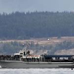 During a 2015 excursion, the fin of a transient killer whale near the stern of Mystic Sea catches attention from some passengers. (Photo by Jill Hein)
