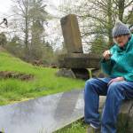 Hank Nelson sits near one of the hundreds of pieces of art he created at Cloudstone Sculpture Park in Freeland over the past 20 years. (Photo by Patricia Guthrie/Whidbey News Group)