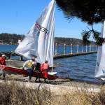 Members of the South Whidbey Yacht Club carry their Laser class sailboats to waters edge at Holmes Harbor. Sunny skies and breezy conditions Sunday made for an ideal early sail into spring on the streamlined sleek boats. Club races usually start in May.
