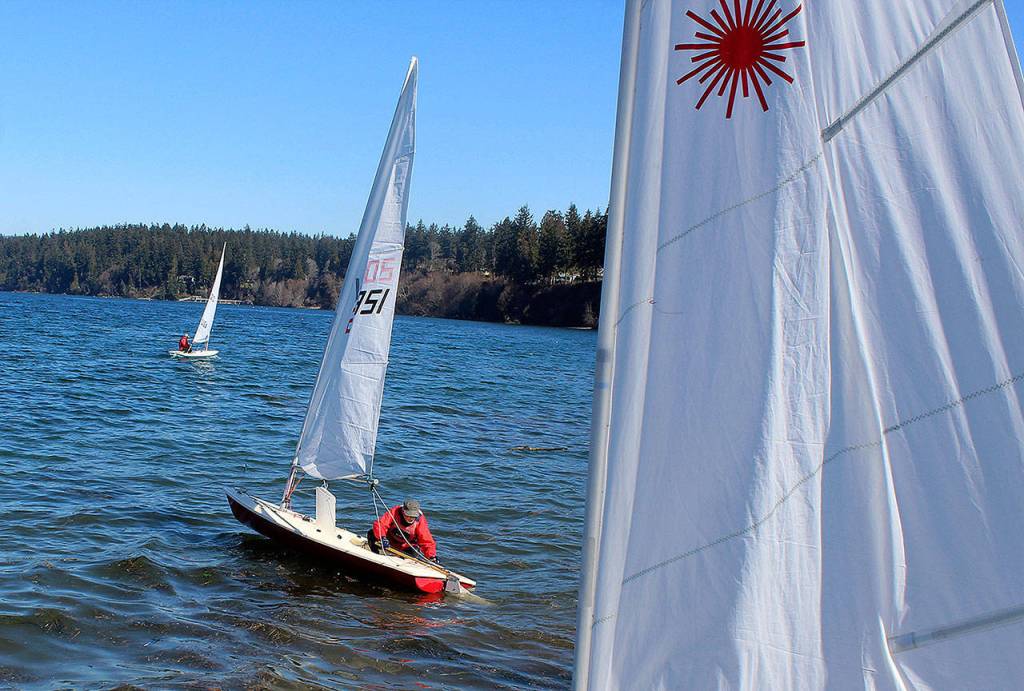 Michael Scott adjusts his Laser sailboat before heading out Sunday with other members of the South Whidbey Yacht Club at Holmes Harbor.