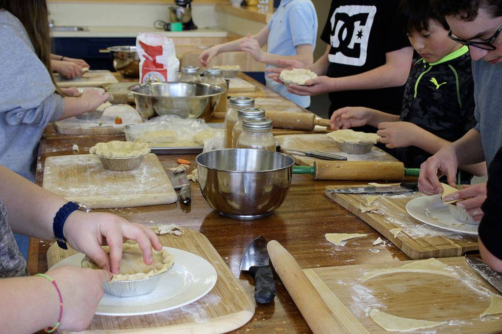 Students put finishing touches on chicken pot pies.