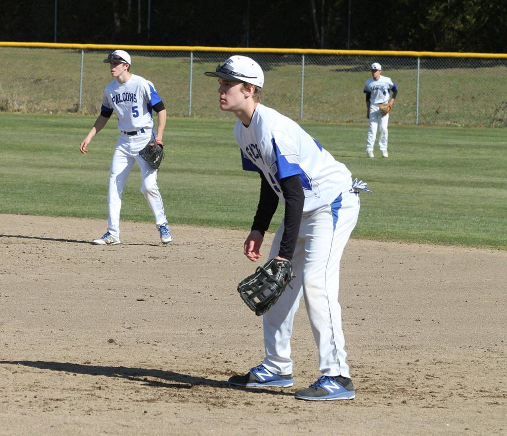 Second baseman Jon Bartel, left, first baseman Nick Young and right fielder Luke Rookstool get ready to play defense.(Photo by Jim Waller/Sound Whidbey Record)