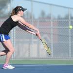 Ashley Ricketts taps the ball over the net in her win in second singles.(Photo by John Fisken)