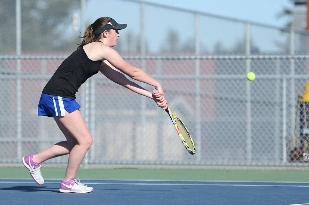Ashley Ricketts taps the ball over the net in her win in second singles.(Photo by John Fisken)