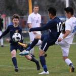 Falcon Graham Colar, right, splits two Tigers to advance the ball. (Photo by Matt Simms)