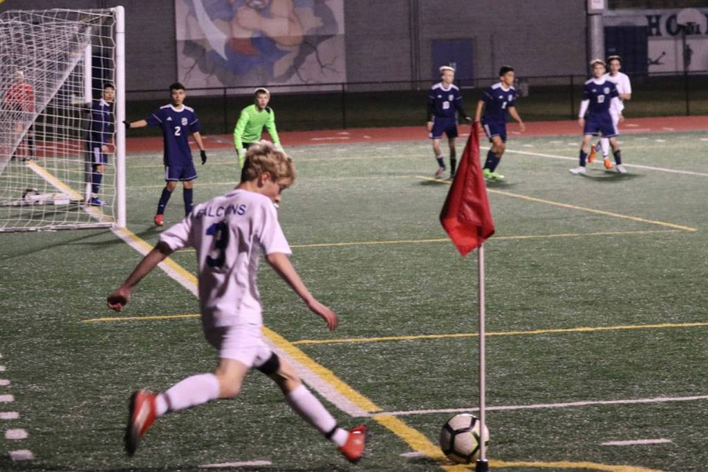Thnomas Simms sends a corner kick toward the Falcon goal.(Photo by Matt Simms)