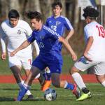 Michael Lux (10) weaves through several Coupeville defenders.(Photo by Matt Simms)