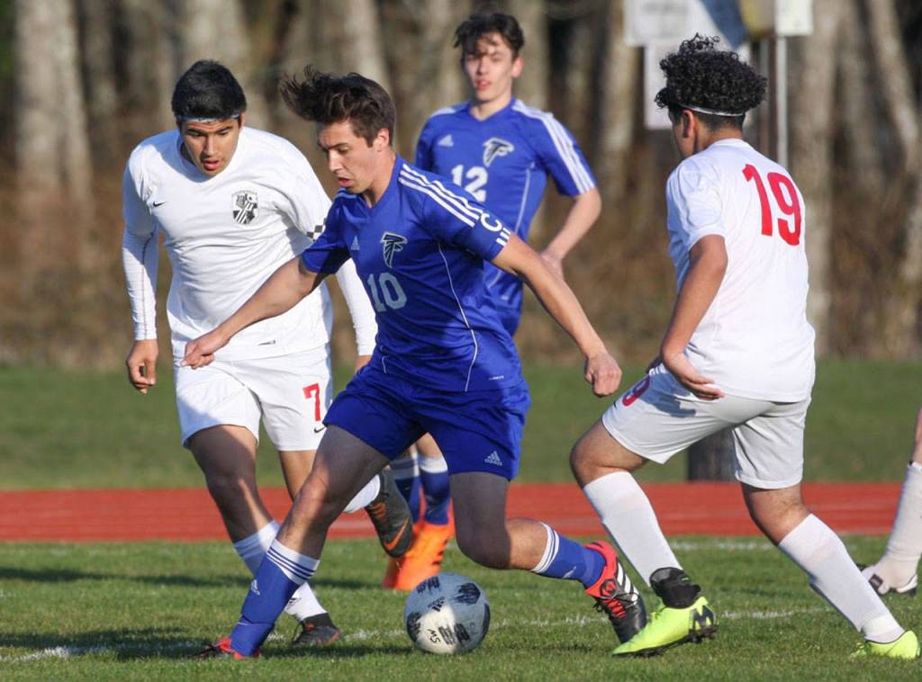 Michael Lux (10) weaves through several Coupeville defenders.(Photo by Matt Simms)