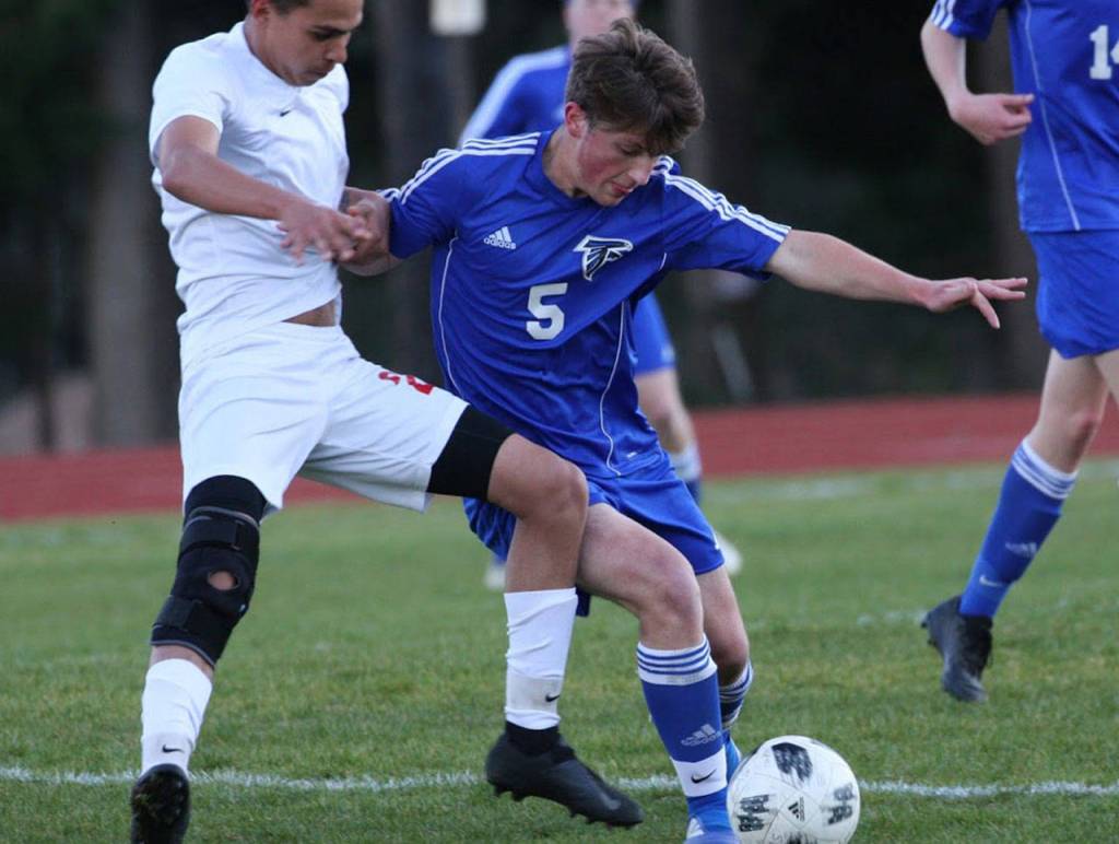 Cormac Workman (5) tussles with Coupevilles Derek Leyva for control.(Photo by Matt Simms)
