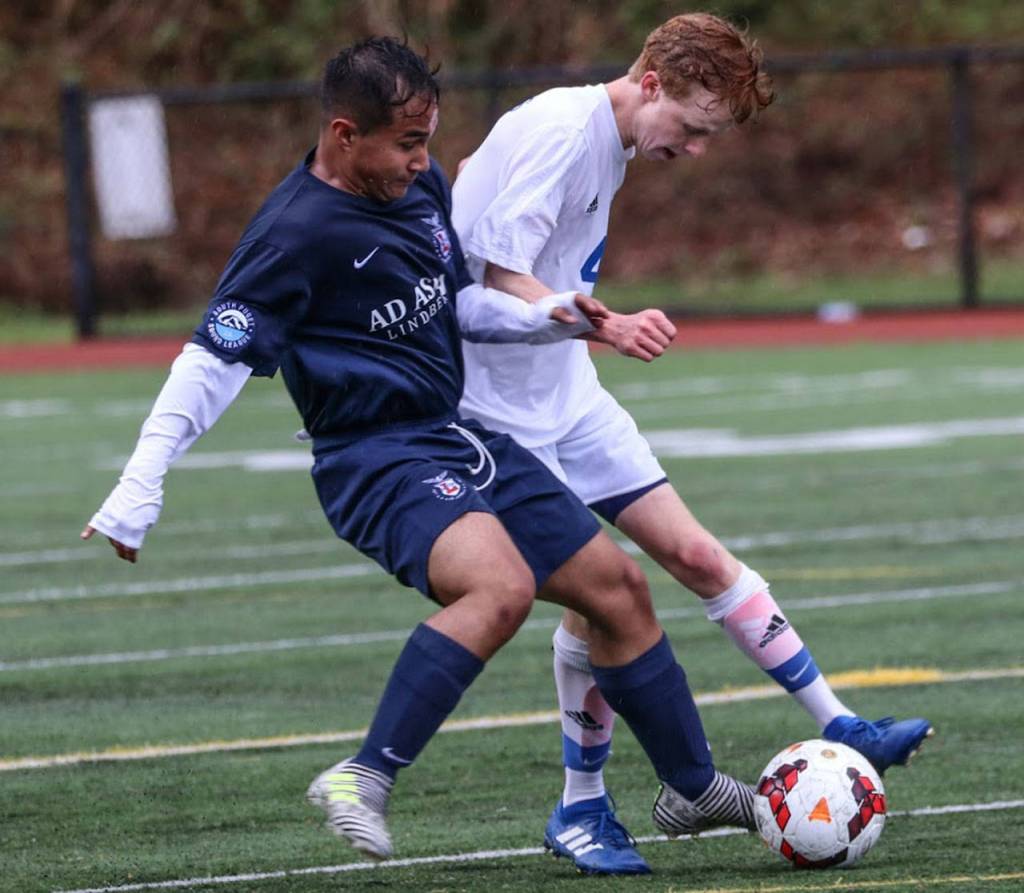 Reilly McVay, right, battles for possession.(Photo by Matt Simms)