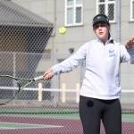 Elizabeth Simmons swats a forehand in her win in second doubles with Ainsley Nelson.(Photo by John Fisken)