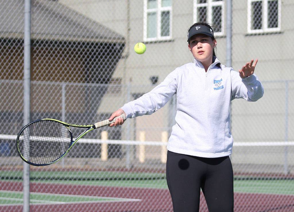 Elizabeth Simmons swats a forehand in her win in second doubles with Ainsley Nelson.(Photo by John Fisken)