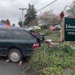 Wayward car backs into mailbox, snarls traffic