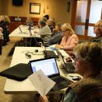 Jane Hayes looks over the sheet explaining food calculations at Thursdays class for Taming Bigfoot Whidbey participants. Shes sitting next to her two teammates, Effie Brown and Dennis Holzer. (Photo by Patricia Guthrie/Whidbey News Group)