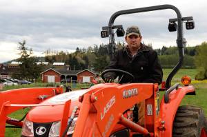 Photos by Maria Matson/ Whidbey News Group.                                Mark Stewarts tractor has come in handy for Boots to Roots. Hes tilled the soil twice so far, and will do so one more time.