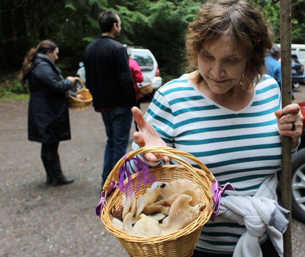 Barbara Elliott shows off a variety of mushrooms she collected during a recent Saturday hike with Whidbey Wild Mushroom Tours on trails maintained by Whidbey Institute.