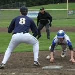 South Whidbeys Alex Black dives safely back into first base. (Photo by Jim Waller/South Whidbey Record)