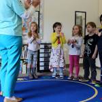 Johnson leads a session of head, shoulders, knees and toes, knees and toes for one of three groups of children rotating through her preschool classroom.
