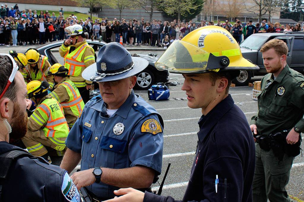 Junior Sam Martin, right, a youth volunteer first responder, spent months organizing the impaired driving demonstration. It involved numerous law enforcment and rescue officials, including his father, Trooper Dave Martin, left, with Washington State Patrol.