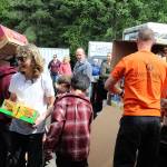 At Good Cheer Food Bank on Thursday, Spencer Jonas passes along a box from the trailer of Whidbey Telecom. The company contributed just over 900 pounds of food, part of the remarkable total of 9,000 pounds Jonas tallied for his annual birthday collection for Good Cheer. (Photo by Patricia Guthrie/Whidbey New Group)