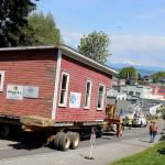 The house-moving company, Nickel Bros, successfully finessed the 30,000-pound wooden structure into its new location Tuesday, rolling it slowly down Second Street. (Photo by Patricia Guthrie/Whidbey News Group)