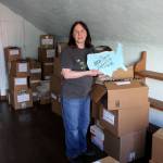 First-time business owner Carol Evans finds an appropriate ceramic piece while setting up inside Whidbey Art Escapes new Langley location. The tiny attic will be one of several spaces where customers can sit and paint. (Photos by Patricia Guthrie/Whidbey News Group)