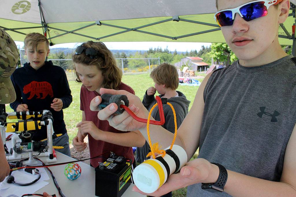 Tyler Know demonstrates how a household hook served as a handle on the robot.