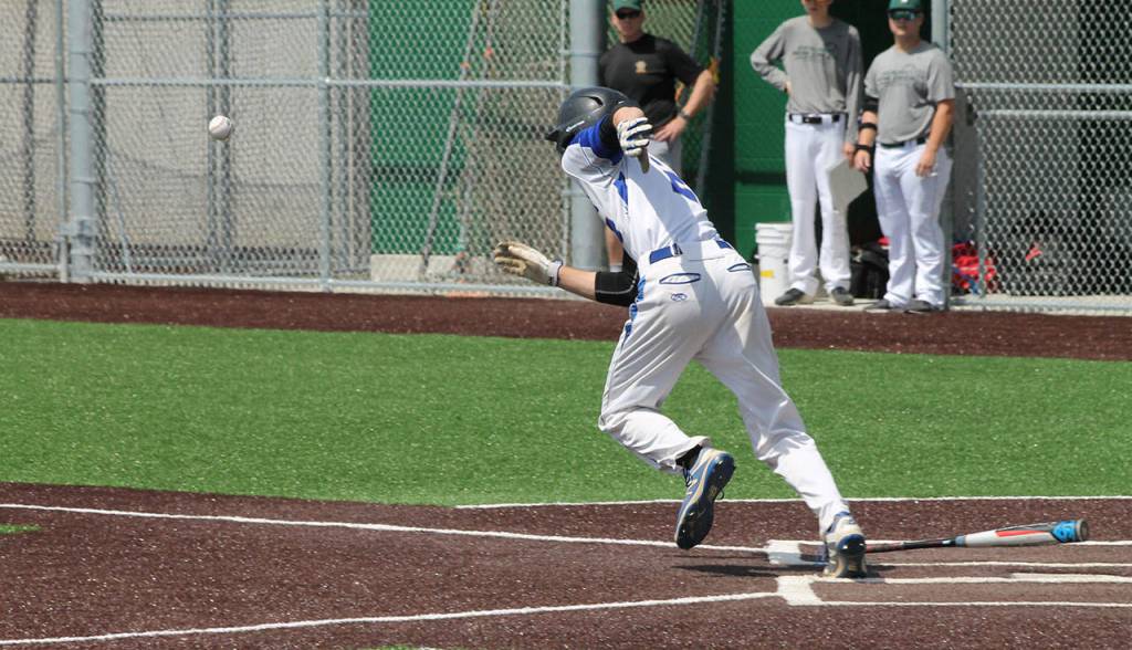 Luke Rookstool drops down a bunt.(Photo by Jim Waller/South Whidbey Record)