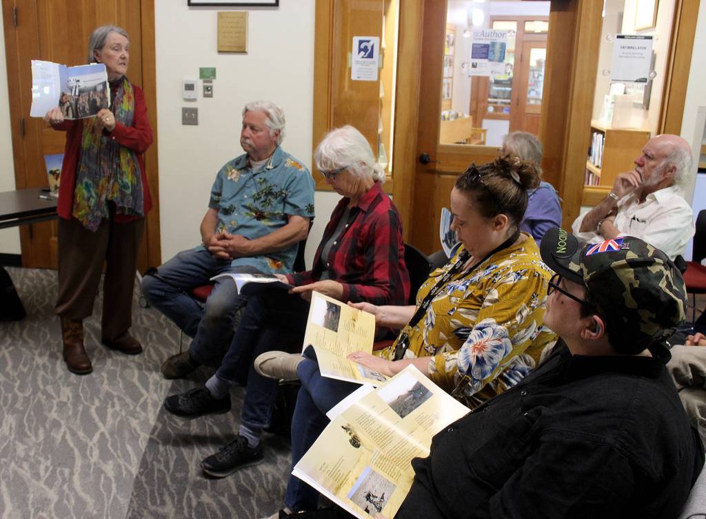 <div>At a Freeland Library presentation Wednesday, Judith Gorman shows some of her sons photographs included in the book, A Soldiers Journal, Last Supper to No Goodbye. (Photo by Patricia Guthrie/Whidbey News Group)</div>