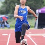 Issiah Gonzales flies to third place and a state berth in the triple jump. He also earned a state berth by winning the high jump.(Photo by John Fisken)